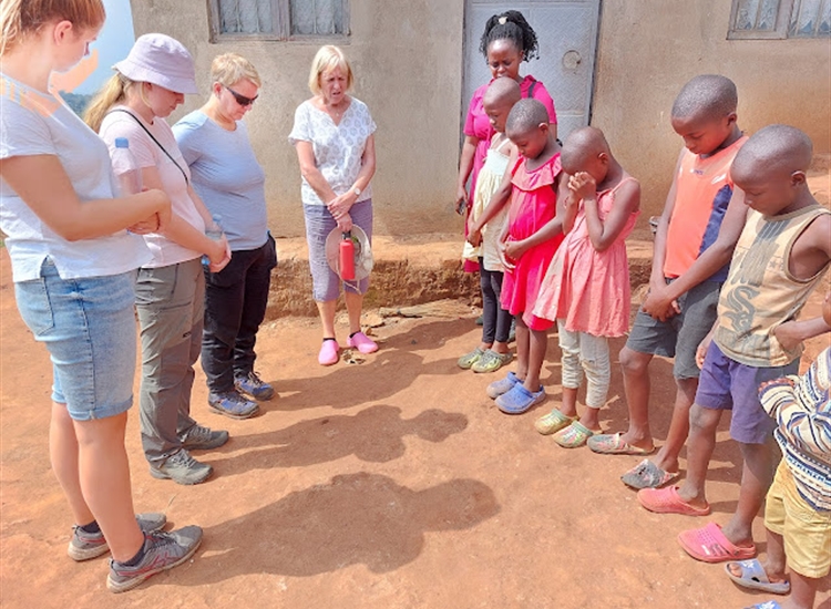 Team praying on village walk